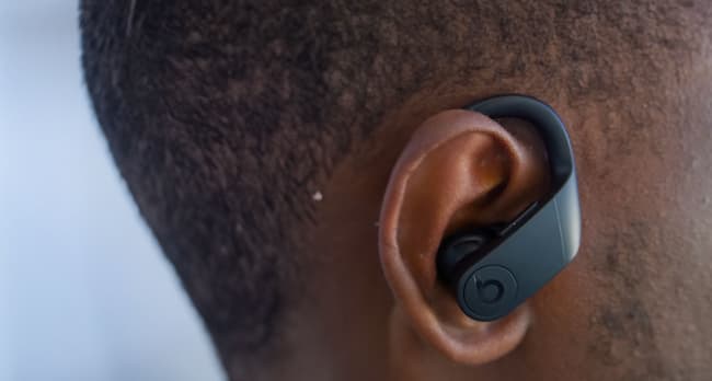 An ear-hook style black earbud inside the ear